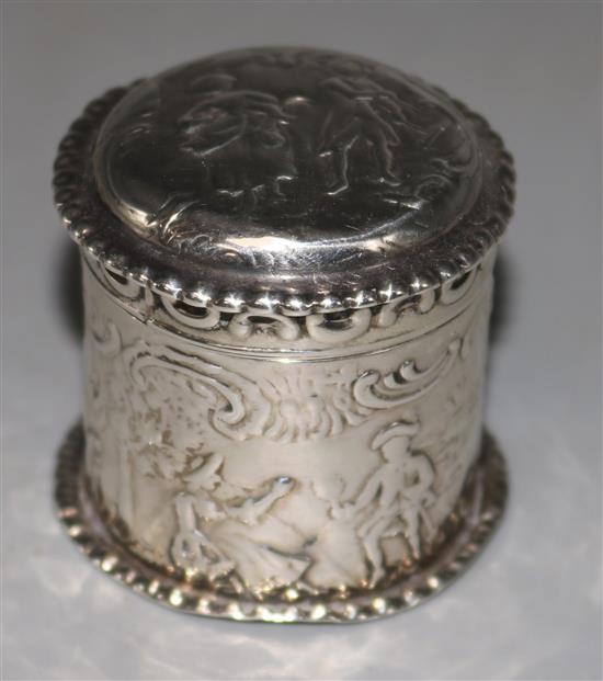 A late 19th century German Hanau? embossed silver lidded cylindrical pill box, 1.5in.